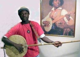 Laemouahuma Daniel Jatta|The Gambia map|Daniel Laemouahuma Jatta playing an akonting