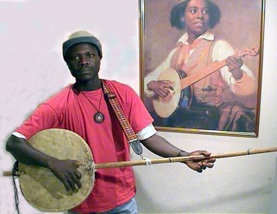 Laemouahuma Daniel Jatta|The Gambia map|Daniel Laemouahuma Jatta playing an akonting