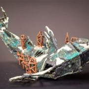 ceramic sculpture of a fish dying of city-viruses