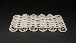 ceramic links in chain mail formation, lying on a cou