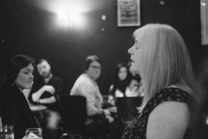Black and white, image of a singers club in Dublin Ireland, focus on Niamh Parsons, tradition bearer. 