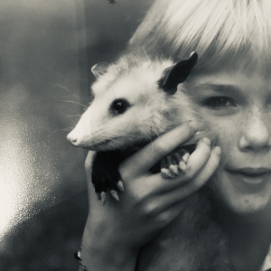 vintage snapshot with little girl and opossum