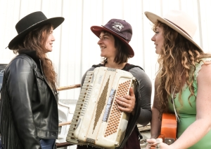 may be 3 women in hats and there's an accordion