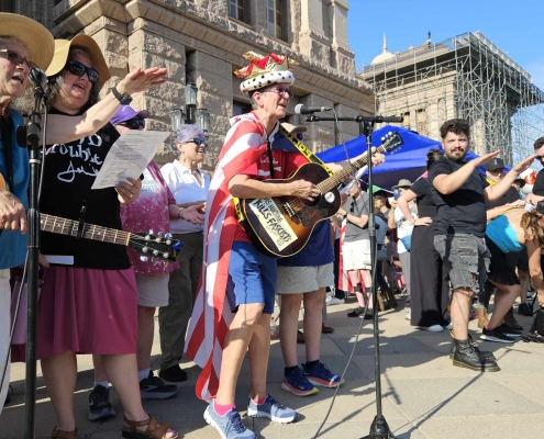 women protestors with guitars